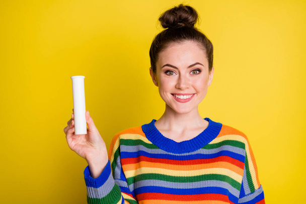 Photo of cute optimistic brunette girl show vitamins wear rainbow sweater isolated on bright yellow color background - Foto, Bild