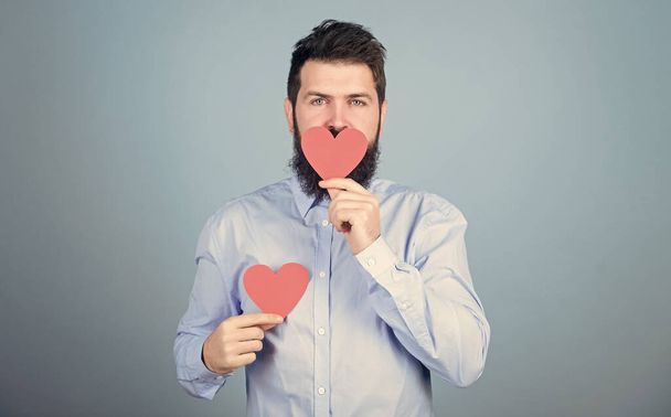 Sweet kiss. Man bearded hipster with heart valentine card. Celebrate love. Guy with beard and mustache in romantic mood. Feeling love. Dating and relations concept. Happy in love. Send kiss to you - Foto, Bild