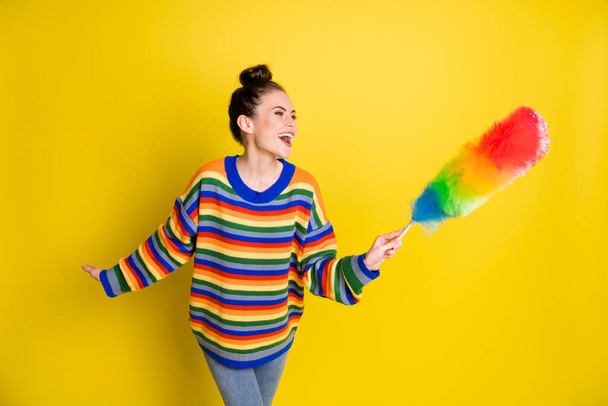 Photo of nice optimistic brunette girl stand clean up wear rainbow sweater isolated on bright yellow color background - Фото, зображення