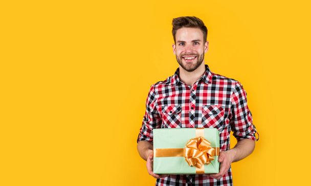 stylish guy with trendy hairstyle wear shirt hold gift box, party - Fotoğraf, Görsel