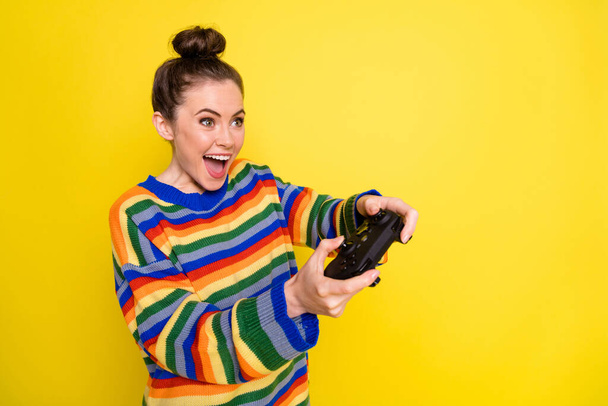 Profile side photo of young attractive woman happy positive smile play video games isolated over yellow color background - Φωτογραφία, εικόνα