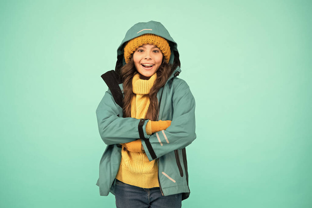 Winter holidays. knitted clothes fashion. cold season weather. outdoor activity for kids. small girl sweater. hat and gloves accessory. no flu. warm clothes sales. happy girl windbreaker jacket - 写真・画像