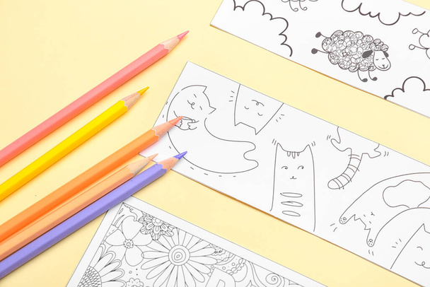 Cute bookmarks with pencils on color background - Photo, Image