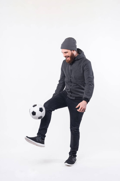 Full length photo of bearded hipster man playing with soccer ball - Photo, Image
