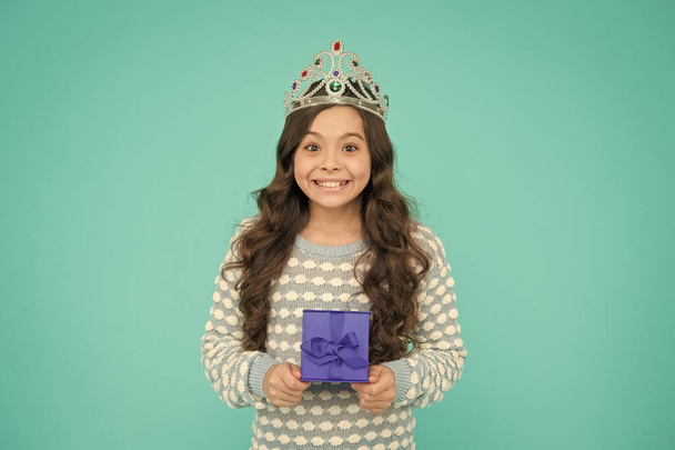 Portrait of cute smiling little girl with gift box. kid in princess crown. happy birthday daughter. Birthday Princess. Kid silver crown symbol of glory. portrait of pride. happy childrens day - Photo, image