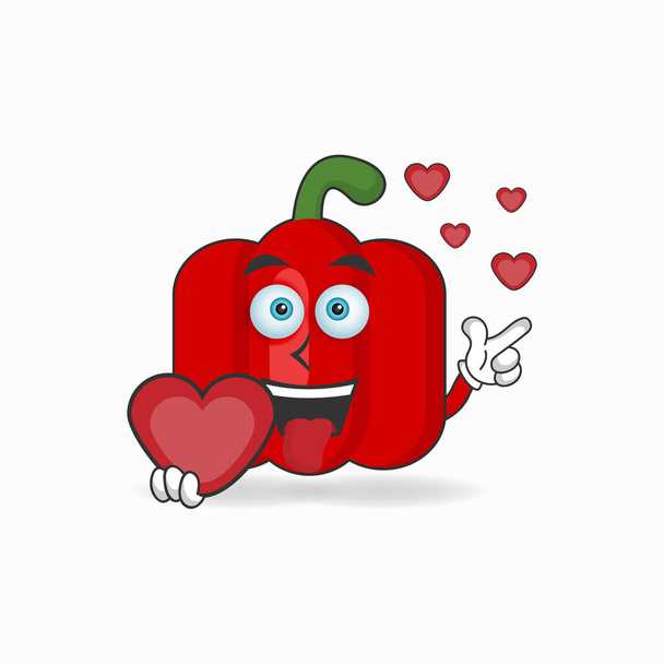 Mascotte de paprika rouge personnage tenant une icône d'amour. - Vecteur, image
