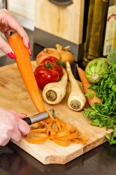 Closeup of woman hands cleaning the carrots - Fotoğraf, Görsel
