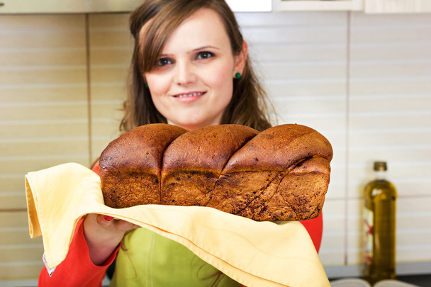 Young woman holding a traditional sponge cake  - Photo, image