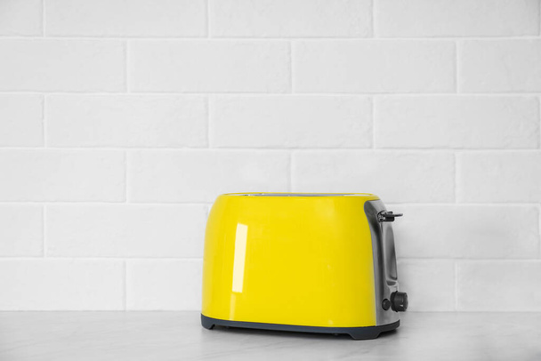 Modern yellow toaster on countertop in kitchen. Space for text - Fotoğraf, Görsel