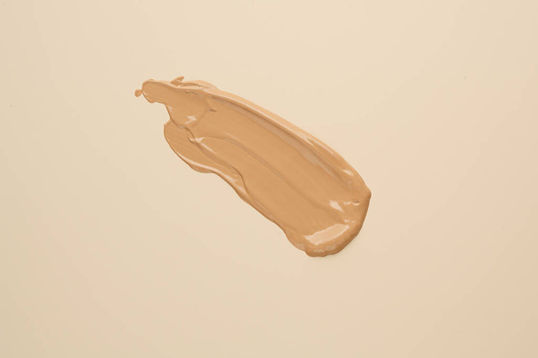 BB, CC cream foundation tonal smudge on nude beige background - Photo, Image