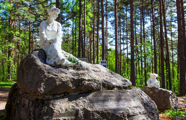 Skulptur von Frau und Teddybär auf Felsen im Wald - Foto, Bild
