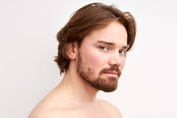 young caucasian shirtless male with long hair and beard posing at camera - Fotografie, Obrázek
