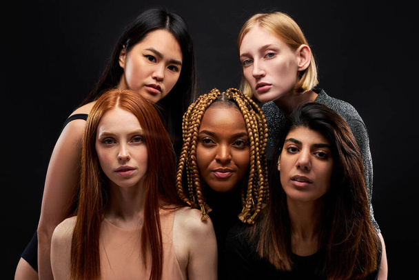portrait of mixed race group of ladies isolated on black - Фото, зображення