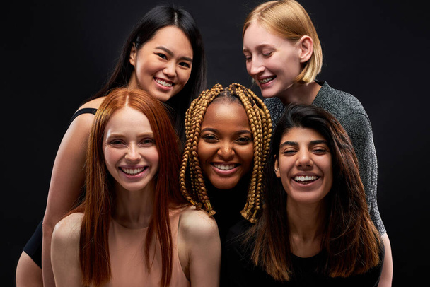 portrait of happy cheerful diverse models laughing, enjoying time together - Fotó, kép