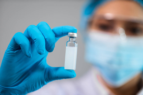 female doctor holding vaccine bottle for injection medicine - Фото, изображение
