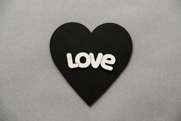 Black heart with the words love on Valentine's Day. - Fotoğraf, Görsel