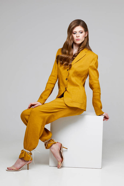 Fashion portrait of young elegant woman in trendy linen suit. Studio shot. - Фото, зображення