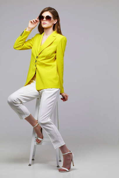 Fashion portrait of young elegant woman in trendy yellow jacket. Studio shot. - Zdjęcie, obraz