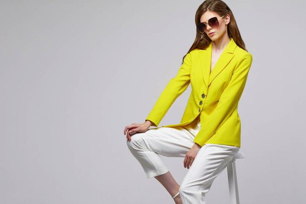 Fashion portrait of young elegant woman in trendy yellow jacket. Studio shot. - Zdjęcie, obraz