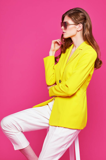 Fashion portrait of young elegant woman in trendy yellow jacket. Studio shot. - Foto, immagini