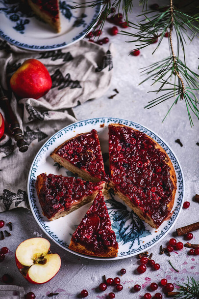 Hot spiced apple, cranberry and ginger upside down cake..rustic style.selective focus - Photo, Image
