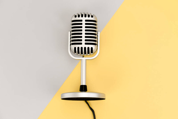 Top view Retro microphone with copy space on grey and yellow background - Photo, Image