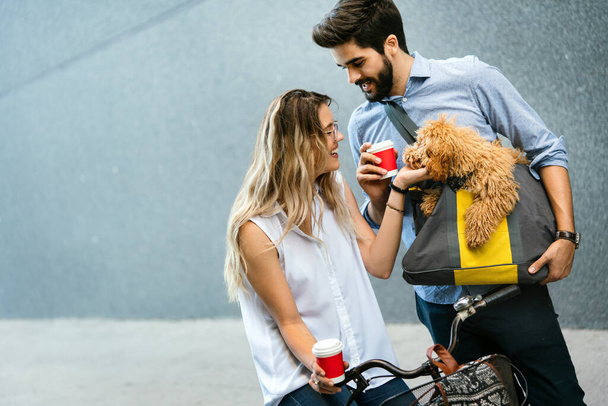 Happy couple in love with dog walking and smiling outdoor - Zdjęcie, obraz