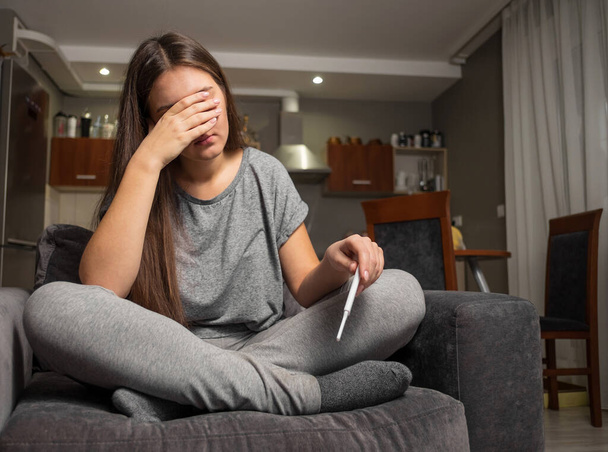 upset young woman and pregnancy test - Фото, зображення