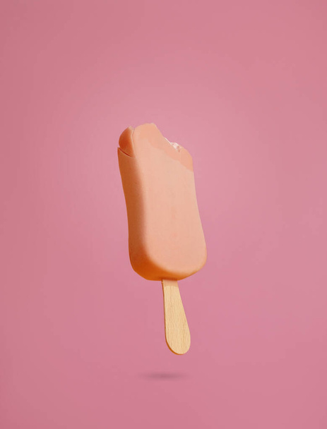 pink ice cream popsicle on pink background bitten off a piece hanging in the air - Fotoğraf, Görsel