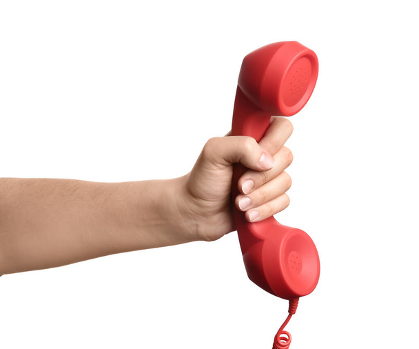 Woman holding red corded telephone handset on white background, closeup. Hotline concept - Fotó, kép