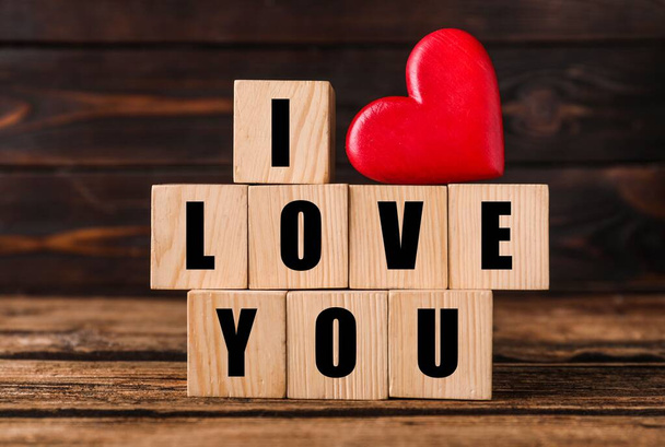 Cubes with words I Love You and red heart on wooden table - Zdjęcie, obraz