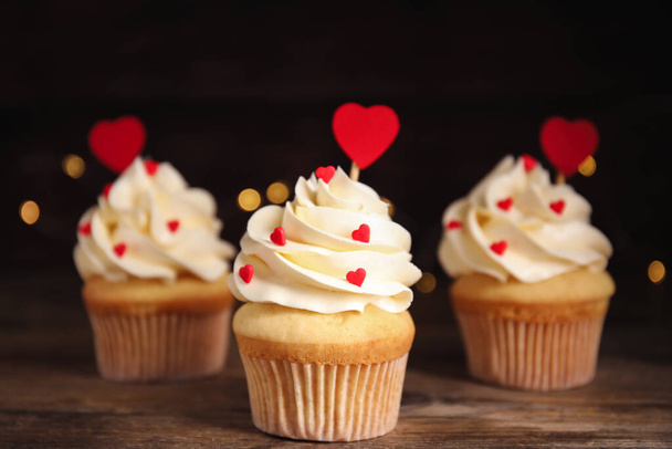 Tasty sweet cupcakes on wooden table. Happy Valentine's Day - Φωτογραφία, εικόνα