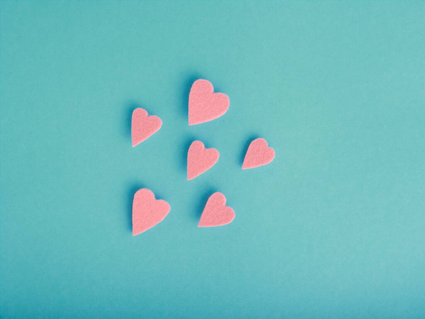 Isolated felt hearts soar over a blue background with copy space - Photo, Image