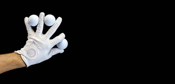 Гравець у рукавичці для гольфу тримає кульки для гольфу між пальцями.. - Фото, зображення