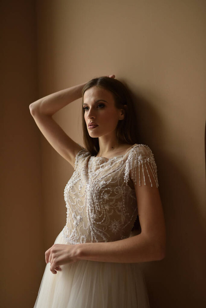 Portrait of a young beautiful woman in an elegant dress. Close-up shot. - Fotó, kép