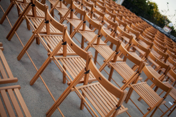 chairs on the roof. Concert hall. many wood chairs. - Photo, Image