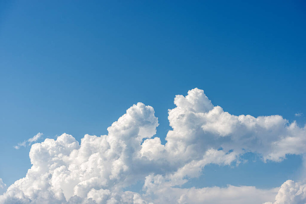 Closeup of a puffy white clouds in a clear blue sky, cumulonimbus. Photography, full frame. - Photo, Image