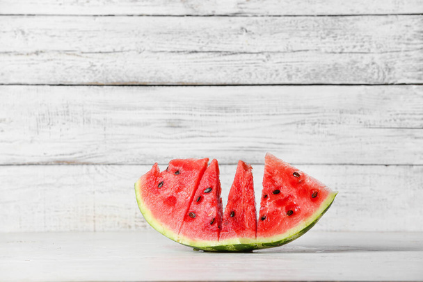 Slices of ripe watermelon on wooden table - Фото, изображение