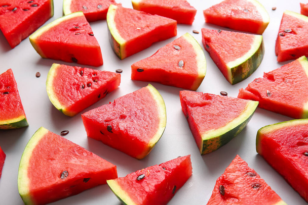 Slices of ripe watermelon on light background - Fotó, kép