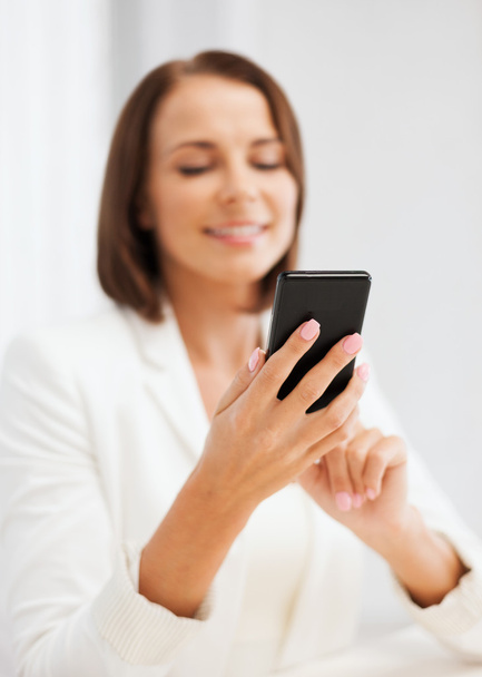 Smiling businesswoman or student with smartphone - Foto, Bild