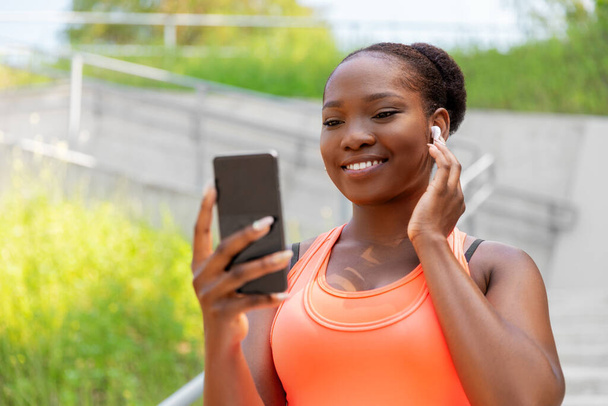 african american woman with earphones and phone - Foto, Imagen