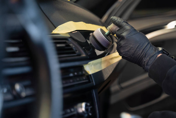 Professional polishing car interior trim. Auto detailing concept  - Photo, Image