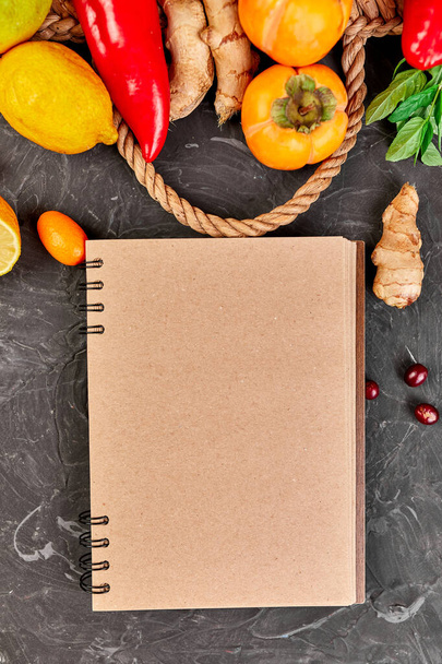 Notebook with healthy products, trendy virus protection food, coronavirus, immunity concept or diet, Vegetables and fruits to boost immune system, Healthy products for Immunity boosting. Flat lay, top view. - 写真・画像