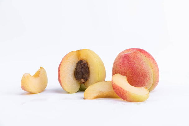 A closeup of cut peaches isolated on a white background - Photo, Image