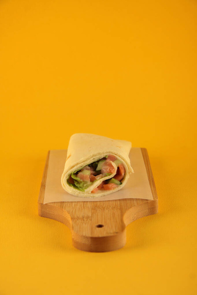 traditional turkish food doner kebab on wooden cutting board against yellow background. Image contains copy space - Foto, Bild
