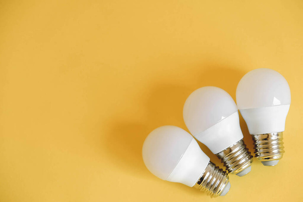 LED light bulbs on yellow background. Top view. Copy, empty space for text. - Photo, Image