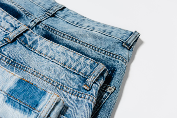 close up view of pair of blue jeans on white background - Valokuva, kuva