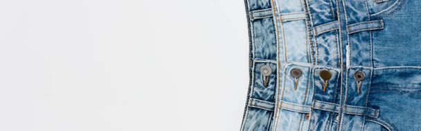 top view of various blue jeans isolated on white with copy space, banner - 写真・画像