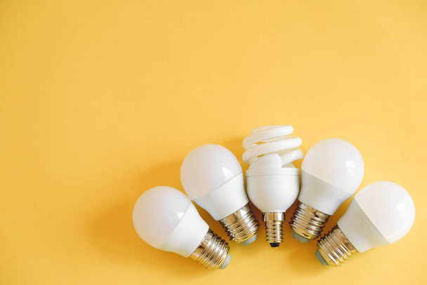 LED light bulbs on yellow background. Top view. Copy, empty space for text. - Foto, Bild