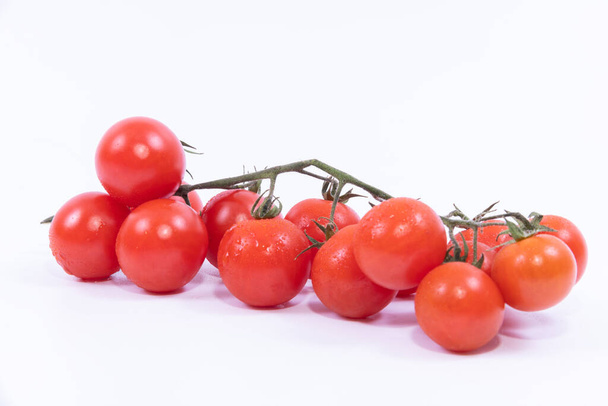 A closeup of fresh cherry tomatoes isolated on a white background - Фото, зображення